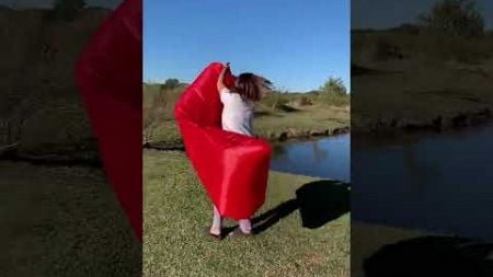 Woman is struggling with her inflatable camping lounger!