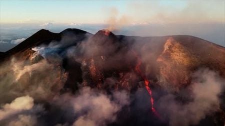 Mount Etna spits lava into night sky