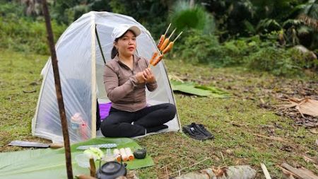 Young girl alone in the forest camping and cooking