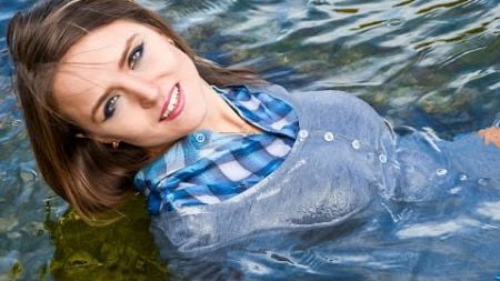 cute girl posing cool in wet clothes on the beach